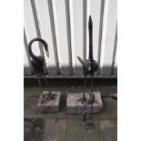 A PAIR OF METAL JAPANESE CRANE FIGURES, both figures with their necks in different positions, on a