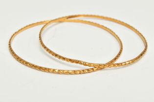 TWO YELLOW METAL BANGLES, each with embossed detail, approximate inner diameter 61mm, stamped 22c,