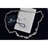 A BOXED SWAROWSKI CRYSTAL NECKLACE, wavy detailed necklace with bezel set colourless crystals,