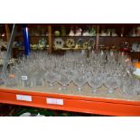 A QUANTITY OF CUT GLASS DRINKING GLASSES, twelve sets/part sets of glasses with some pairs and