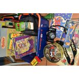 TWO BASKETS OF A CAMERA, BOOKS, TOYS AND GAMES, to include a cased Minolta Dynax 700si SLR camera