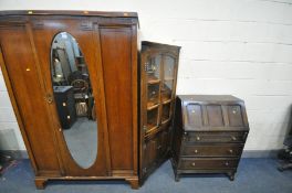 A LATE 20TH CENTURY OAK SINGLE DOOR WARDROBE, the door with an oval bevelled edge, on bracket