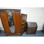 A LATE 20TH CENTURY OAK SINGLE DOOR WARDROBE, the door with an oval bevelled edge, on bracket