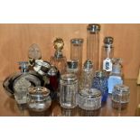 A COLLECTION OF MAINLY EARLY 20TH CENTURY GLASS SCENT BOTTLES AND SIMILAR ITEMS, many with silver