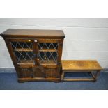 A LATE 20TH CENTURY OAK TWO DOOR LEAD GLAZED CABINET, with two bottom linenfold cupboard doors,