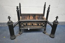 A HEAVY CAST IRON GOTHIC TYPE FIRE GRATE, flanked by andirons width 86cm x depth 55cm x height 76cm