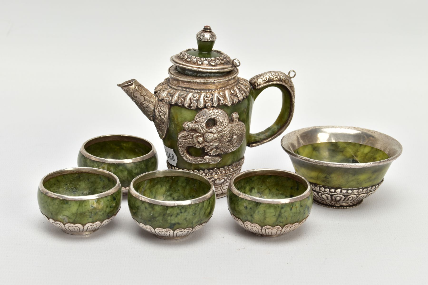 A JADE AND WHITE METAL TEA SET, of decorative oriental design, to include a tea pot with lid and