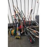 A QUANTITY OF GARDEN TOOLS, to include five spades, one shovel, outdoor brushes, axe, garden shears,