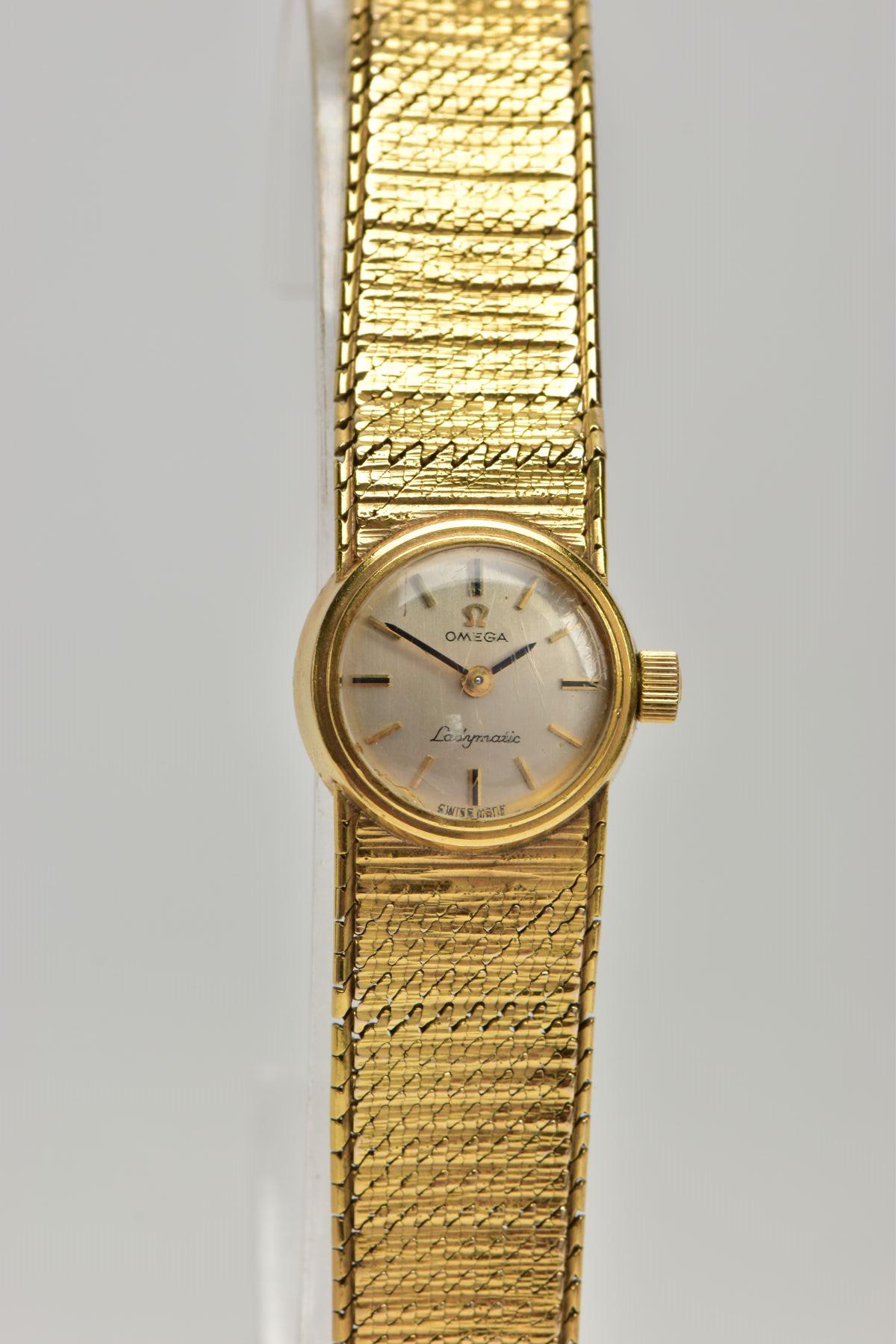 A LADIES 9CT GOLD 'OMEGA' WRISTWATCH, a hand wound movement, round silver tone dial signed 'Omega