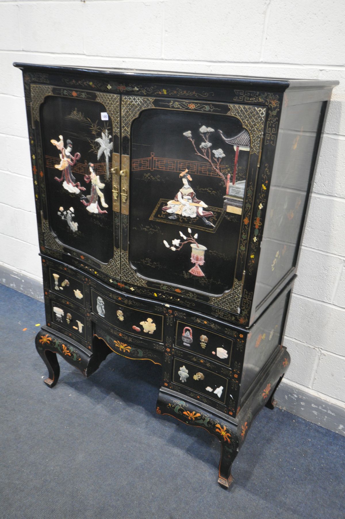 A 20TH CENTURY EBONISED JAPANNED TWO DOOR CUPBOARD, with chinoiserie decoration, the base with an