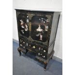 A 20TH CENTURY EBONISED JAPANNED TWO DOOR CUPBOARD, with chinoiserie decoration, the base with an