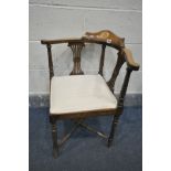 AN EDWARDIAN MAHOGANY AND INLAID CORNER CHAIR, with a shaped back rest, cream stripped upholstery,