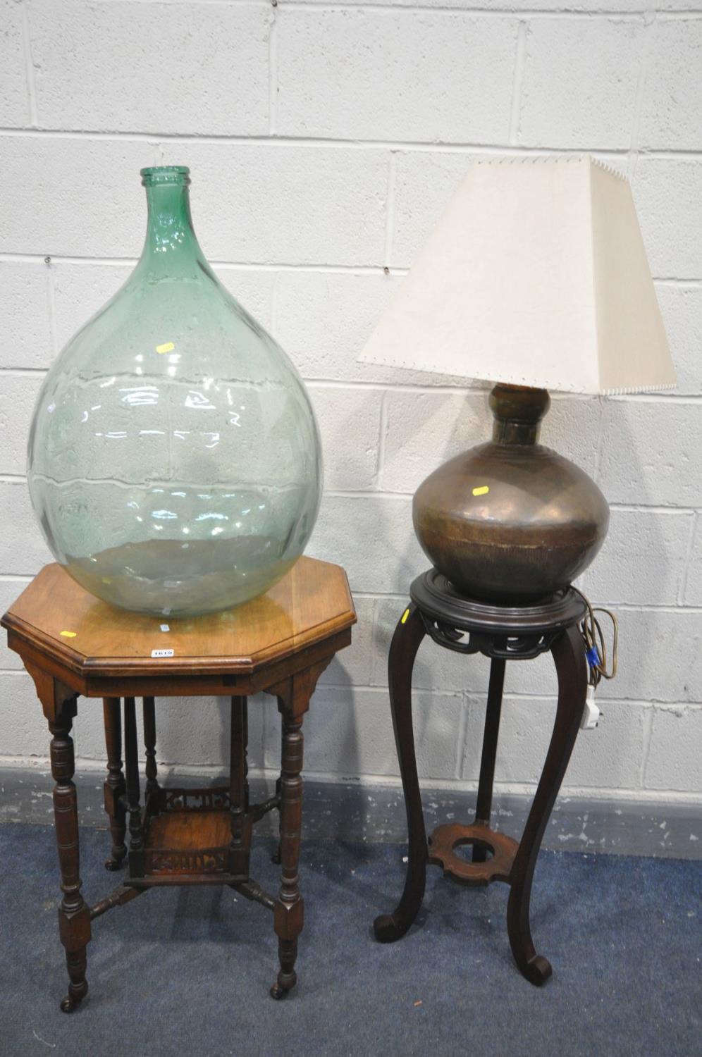 AN EDWARDIAN WALNUT CENTRE TABLE, 58cm x height 75cm, a demijohn, a mahogany torchere stand and a