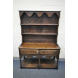 AN EARLY 20TH CENTURY OAK DRESSER with a two tier plate rack and two drawers, on turned front legs