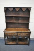 AN EARLY 20TH CENTURY OAK DRESSER with a two tier plate rack and two drawers, on turned front legs