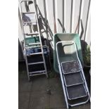 TWO FOLDING GARDEN LOUNGER CHAIRS, along with a plastic wheelbarrow, and two metal ladders (5)
