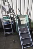 TWO FOLDING GARDEN LOUNGER CHAIRS, along with a plastic wheelbarrow, and two metal ladders (5)
