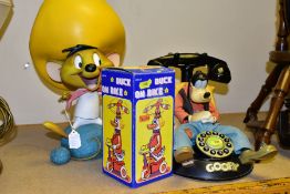 A WARNER BROS 'GOOFY' PUSH BUTTON PHONE (mybelle805), a wind up tin duck on a bike (boxed), also