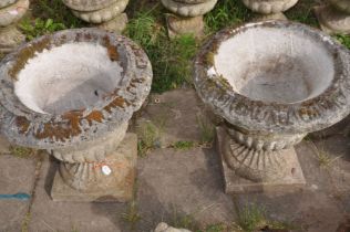 A PAIR OF COMPOSITE CAMPAGNA GARDEN URN, on a square plinth, diameter 52cm x height 56cm (