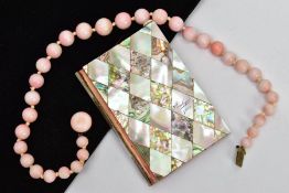 A CERAMIC BEAD NECKLACE AND AN AIDE MEMOIRE, a graduated pink glazed ceramic bead necklace, fitted