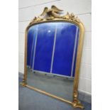 A 19TH CENTURY GILTWOOD OVERMANTEL MIRROR, with foliate decoration flanking an eagle surmount, width
