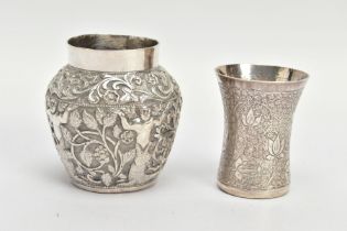 TWO WHITE METAL VASES, both of Indian design, the first decorated with raised foliate scenes,