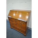 A GEORGIAN OAK AND FAN INLAID BUREAU, enclosing a fitted interior, and an arrangement of seven