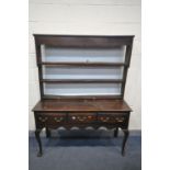 A GEORGIAN OAK DRESSER, with a triple cascading plate rack, and three frieze drawers, on cabriole