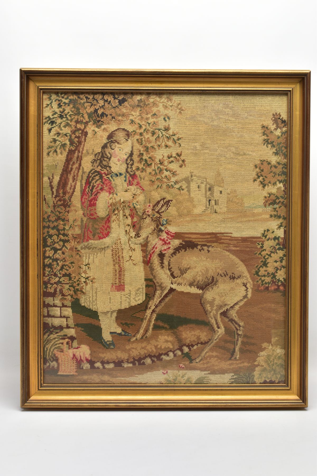 A VICTORIAN HAND SEWN TAPESTRY DEPICTING A YOUNG FEMALE FIGURE PUTTING FLOWER GARLANDS ONTO A
