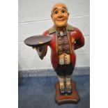 A CARVED AND PAINTED WOODEN FIGURE OF A BUTLER HOLDING A SMALL CIRCULAR TRAY, height 102cm (