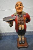 A CARVED AND PAINTED WOODEN FIGURE OF A BUTLER HOLDING A SMALL CIRCULAR TRAY, height 102cm (