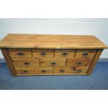 A SOLID PINE BANK OF NINE DRAWERS, with iron drop handles, length 178cm x depth 50cm x height