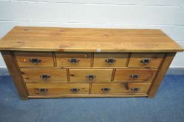 A SOLID PINE BANK OF NINE DRAWERS, with iron drop handles, length 178cm x depth 50cm x height