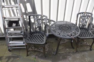 A PLASTIC CIRCULAR GARDEN TABLE, diameter 68cm x height 65cm and two armchairs, along with three