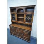 AN OLD CHARM OAK DRESSER, the top with an arrangement of shelves and glazed doors, above a base with