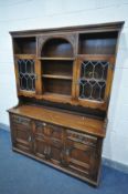 AN OLD CHARM OAK DRESSER, the top with an arrangement of shelves and glazed doors, above a base with