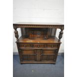 A LATE 20TH CENTURY OAK COURT CUPBOARD, with single upper door, flanked by two carved supports, base