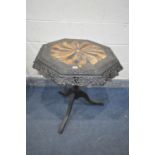 A 19TH CENTURY EBONISED CARVED WOOD OCTAGONAL TRIPOD OCCASIONAL TABLE, the top with a multi wood