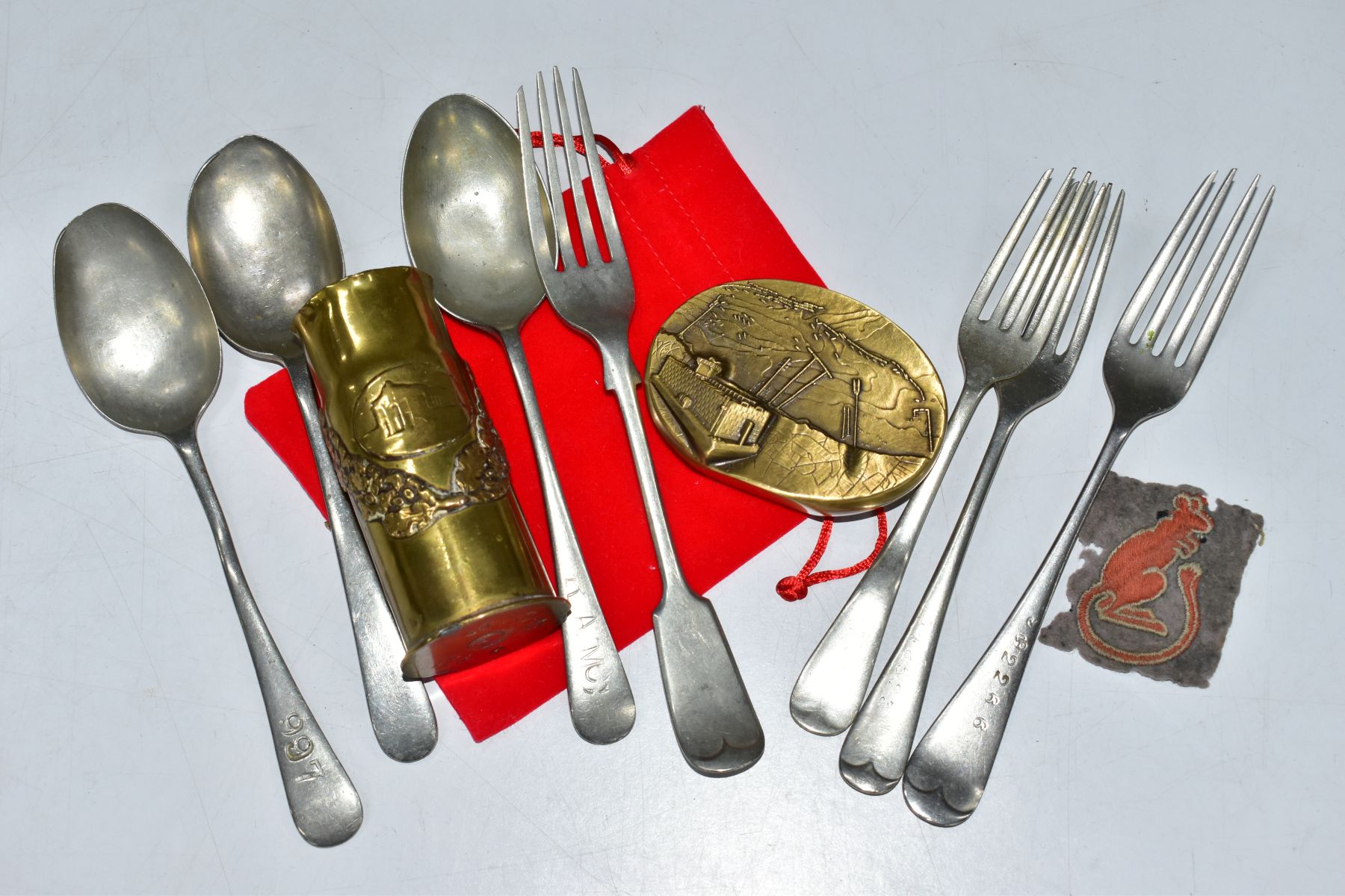 A BOX CONTAINING SEVEN ITEMS OF MILITARY RELATED CUTLERY, forks, spoons, a WW2 era Desert Rats