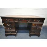 A MAHOGANY PEDESTAL DESK, with tanned and tooled leather inlay, with an assortment of eight drawers,