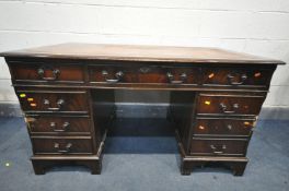 A MAHOGANY PEDESTAL DESK, with tanned and tooled leather inlay, with an assortment of eight drawers,