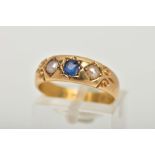 A LATE VICTORIAN 18CT GOLD RING, centring on a star set, cushion cut blue sapphire, flanked with