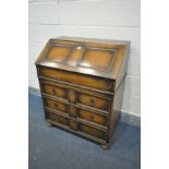 AN OAK BUREAU, with a fitted interior, and three exterior drawers, width 77cm x depth 47cm x