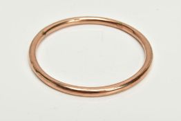 A ROSE GOLD TONE BANGLE, plain polished hollow bangle, stamped 9ct, approximate internal diameter