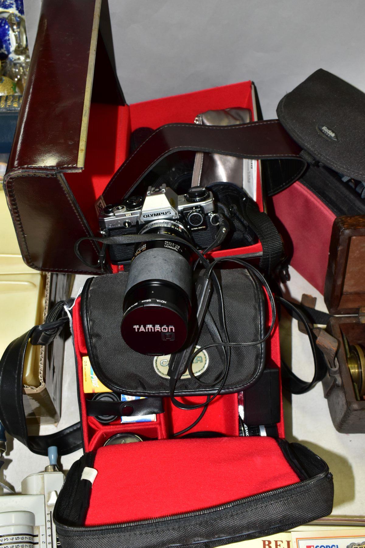 THREE BAGS OF PHOTOGRAPHIC EQUIPMENT ETC, to include an Olympus OM10 camera body with an Olympus