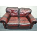 AN OXBLOOD LEATHER TWO SEATER SETTEE, length 152cm x depth 97cm x height 75cm
