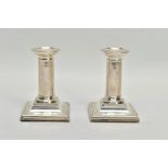 A PAIR OF SILVER DWARF CANDLE STICK HOLDERS BY HORACE WOODWARD & CO LTD, each designed as plain