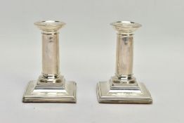 A PAIR OF SILVER DWARF CANDLE STICK HOLDERS BY HORACE WOODWARD & CO LTD, each designed as plain