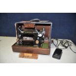 A SINGER SEWING MACHINE with foot pedal and light in blue case (PAT pass and working)
