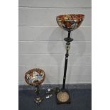 A METAL STANDARD LAMP, with a tiffany style floral lamp shade, a blown glass section, the base